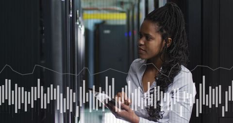 African American Woman Analyzing Data in Modern Server Room