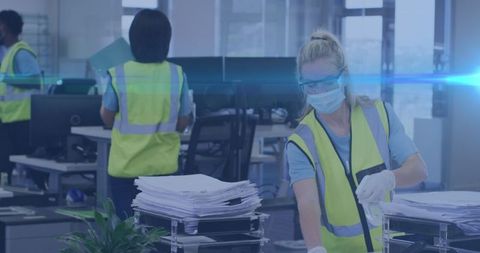 Worker sanitizing office for covid-19 safety measures