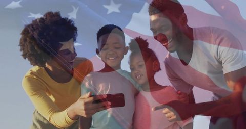 Family celebrating patriotism with smartphone and flag overlay