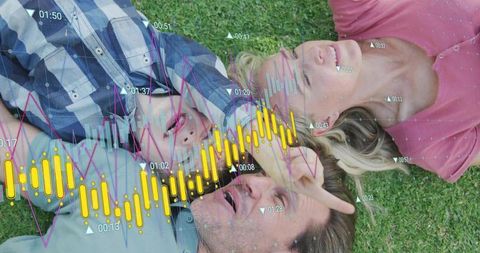 Family lying on lawn with digital overlays showing audio waveforms, charts and data