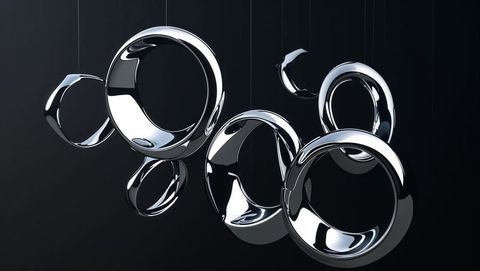 Metallic chrome rings suspended in dark studio