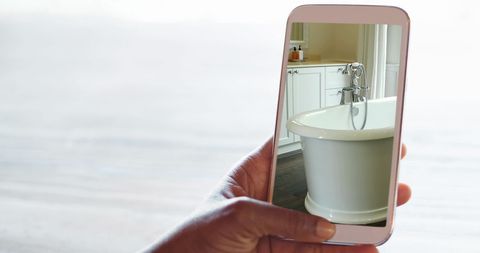 Person Holding Smartphone Showing Bathroom Shower Tub Interior
