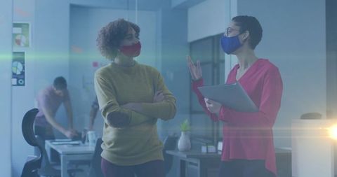 Two Diverse Female Colleagues Collaborating in Modern Office