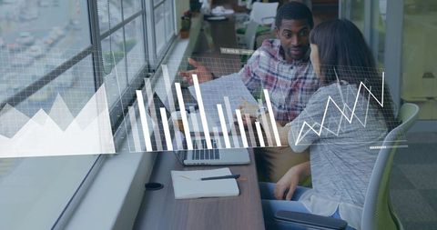 Diverse team analyzing business data with graphic overlay in modern office