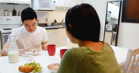 Couple Enjoying Healthy Breakfast Together in Kitchen