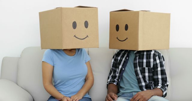 Friends Sitting on Couch with Smiley Face Boxes on Heads - Download Free Stock Images Pikwizard.com