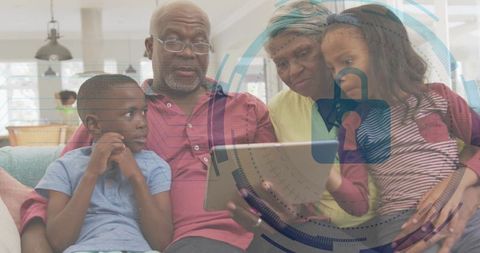 Grandparents and grandchildren sharing tablet with digital security overlay, family bonds