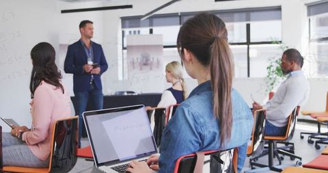 Interactive corporate seminar with professional trainer in modern office