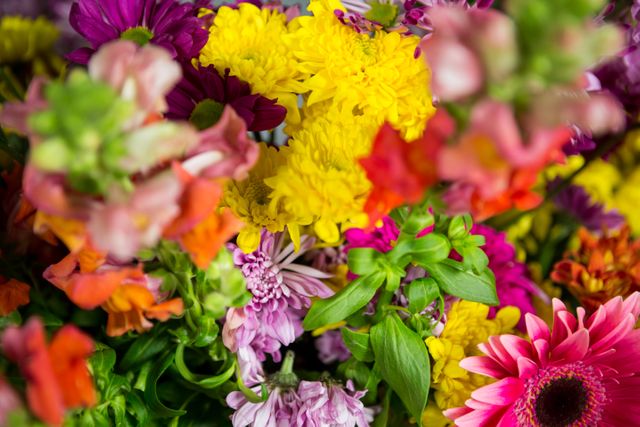 Vibrant and colorful flower arrangement featuring a variety of blooms in a florist shop. Ideal for use in marketing materials for florists, gardening blogs, spring and summer promotions, or as a decorative element in design projects.