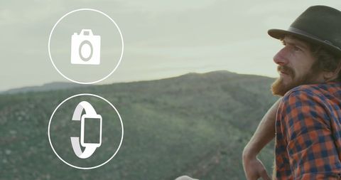 Exploring Connectivity: Man with Holographic Network Icons in Mountains - Download Free Stock Images Pikwizard.com