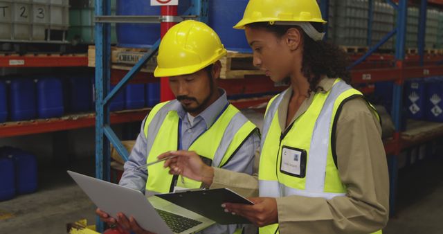 Warehouse Workers Wearing Safety Gear Using Laptop and Clipboard - Download Free Stock Images Pikwizard.com