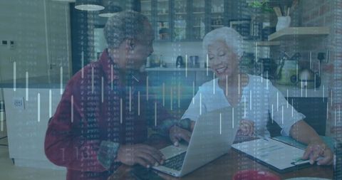 Senior couple reviewing financial plans in modern kitchen