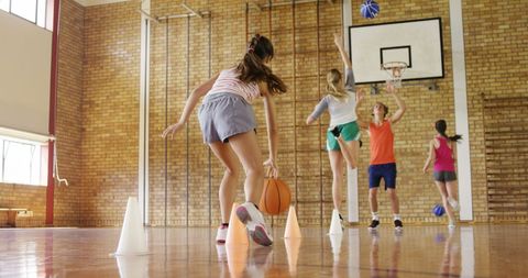 High School Students Playing Basketball in Gym