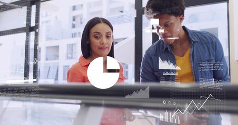 Two colleagues analyzing interactive data dashboard with charts and analytics overlays