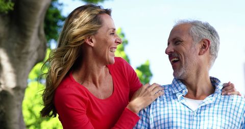 Happy Mature Couple Laughing Outdoors in Sunlight - Download Free Stock Images Pikwizard.com