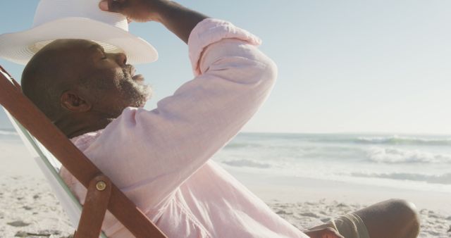 Relaxed Senior Black Man Lounging on a Sunny Beach Chair - Download Free Stock Images Pikwizard.com