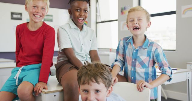 Happy multicultural boys enjoying time together in sunny classroom - Download Free Stock Images Pikwizard.com