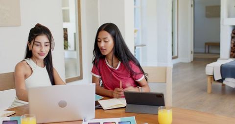 Diverse Female Friends Collaborating on Creative Design Project