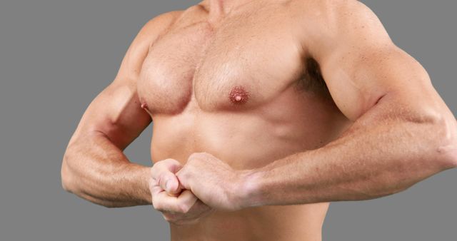 A middle-aged man displays his toned biceps and chest, epitomizing fitness and strength. - Download Free Stock Photos Pikwizard.com