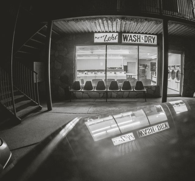 Black and White Laundromat at Night with Empty Chairs - Download Free Stock Photos Pikwizard.com