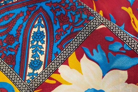 Vibrant bohemian floral paisley fabric pattern with bold blue, red and yellow colors design