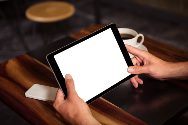 Hands Holding Transparent Tablet at Wooden Cafe Table - Download Free Stock Videos Pikwizard.com