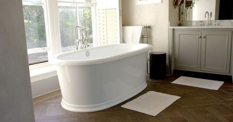 Freestanding Bathtub in Elegant Modern Bathroom with Large Window