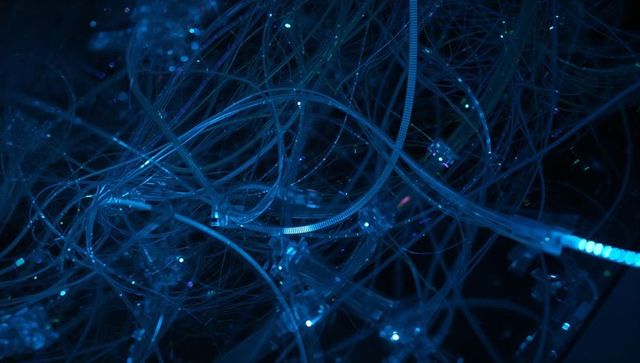 Glowing blue fiber optic mesh with translucent tubing and led connectors, macro tech