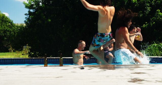 A group of young people are enjoying a sunny day by the pool, splashing water and jumping in, with copy space. Their joyful activities convey the carefree spirit of summer and leisure time with friends.