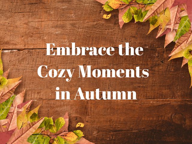 Text quote 'Embrace the Cozy Moments in Autumn' overlay on wooden background with scattered colorful leaves. Perfect for social media posts, blogs, autumn-themed decorations, and seasonal greetings.