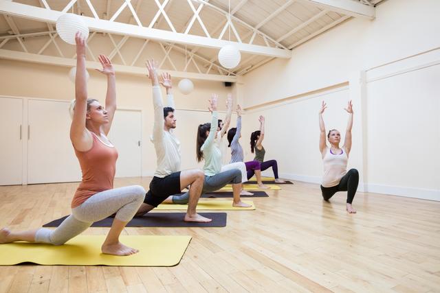 Could be used in articles or advertisements promoting yoga classes, group fitness, or wellness programs. Ideal for illustrating healthy lifestyles, fitness routines, and team activities in a community setting. Suitable for use by fitness centers, yoga studios, or health and wellness blogs.