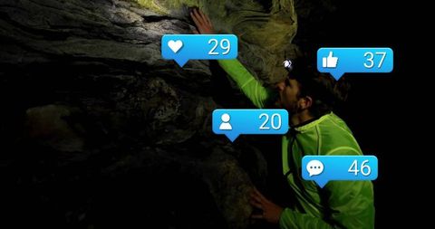 Night cave climber interacting with social media overlay