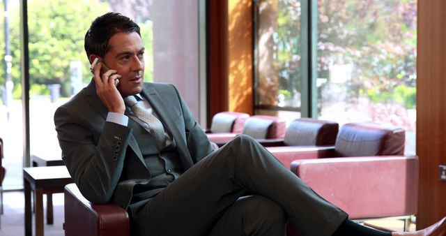 Businessman Talking on Mobile Phone in Modern Office Lobby - Download Free Stock Images Pikwizard.com