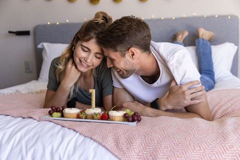 Smiling Couple Celebrates Anniversary Together on Cozy Bed