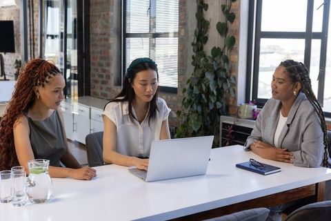 Diverse Female Coworkers Collaborating in Modern Office Setup