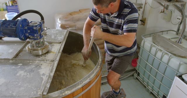 Worker Mixing Ingredients in Industrial Cheese Making Process - Download Free Stock Images Pikwizard.com