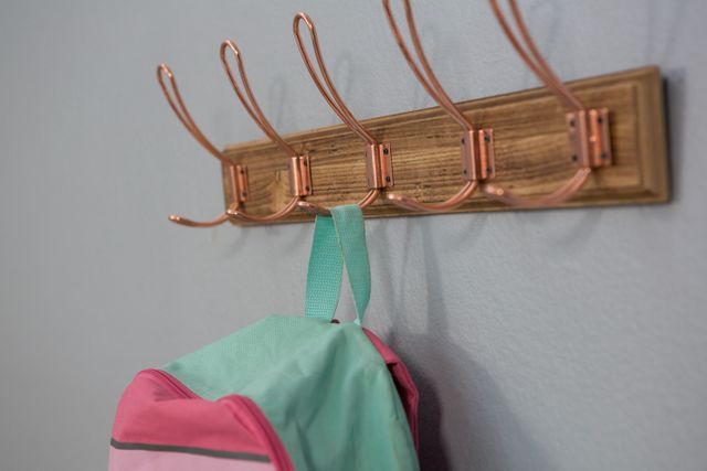 Close-up of schoolbag hanging on hook