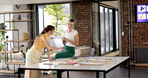 Collaborative Brainstorming Among Diverse Female Coworkers in Modern Office