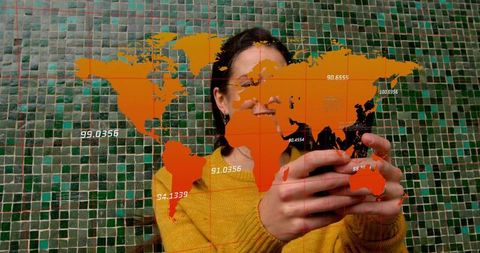 Woman using smartphone revealing interactive world map overlay smiling against green mosaic