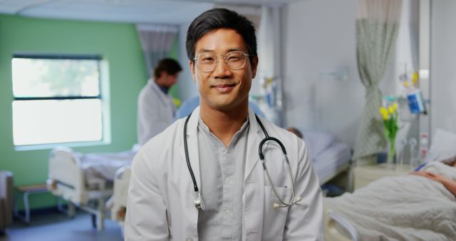 Confident Doctor Standing in Hospital Ward with Colleagues - Download Free Stock Images Pikwizard.com