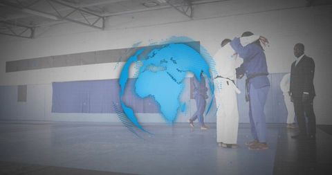 Judo athletes practicing grappling on blue mats with digital globe overlay