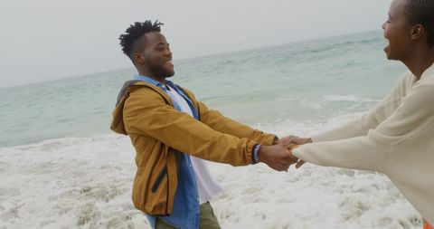 Joyful African American Couple Enjoying Time at Beach Shoreline
