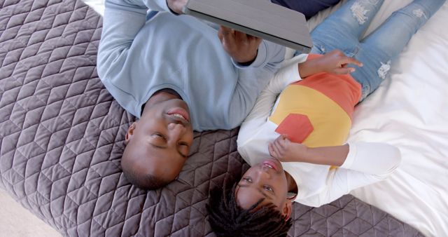 Father and Daughter Relaxing on Bed Using Tablet - Download Free Stock Images Pikwizard.com