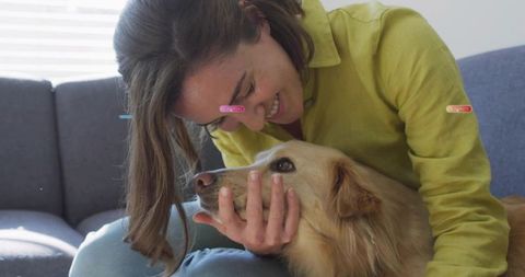 Young Woman Bonding with Golden Retriever on Sofa