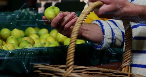 Shopper selecting green apple from basket with augmented reality hud for smart retail