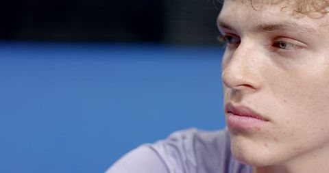 Contemplative Male Athlete on Tennis Court in Sportswear