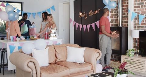 Diverse Friends Preparing for Baby Shower Celebration at Home