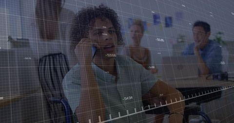 Businessman in Wheelchair Discussing Strategy with Stock Chart Overlay