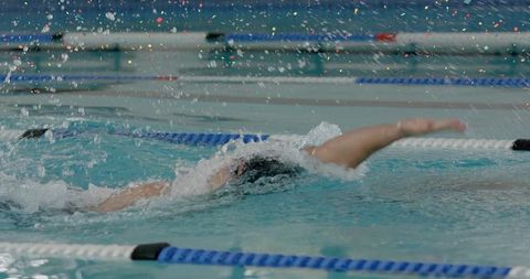 Competitive Swimmer Mastering Front Crawl Stroke in Pool Lane