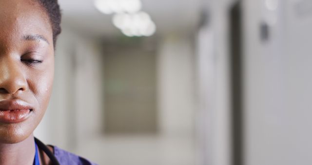 Female Nurse Meditating Peacefully in Hospital Corridor - Download Free Stock Images Pikwizard.com